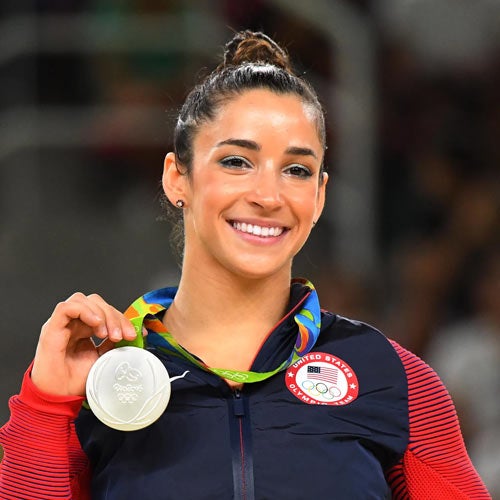 Aly Raisman proudly holds up a gold medal
